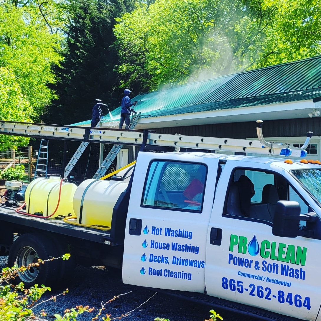 Summertime pressure washing metal roof cleaning.